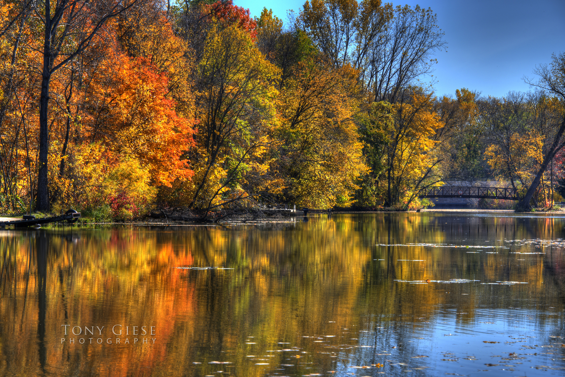 Gorgeous reflections of fall colors over Elm Creek Park Reserve, Maple Grove Minnesota. Photography by Tony Giese.