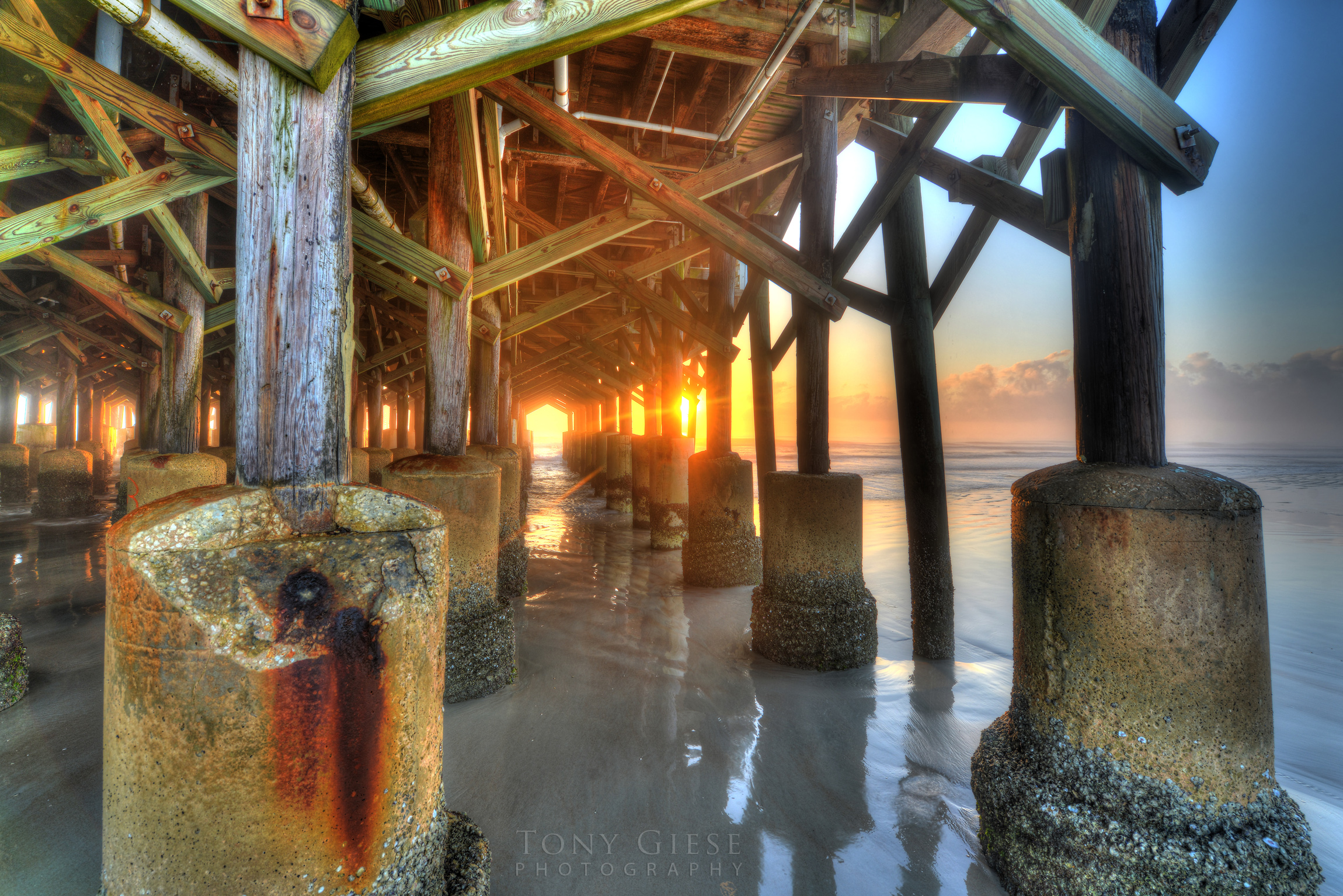 Sunrise under the Daytona Beach Main Street Pier. Photographed by Tony Giese Photography
