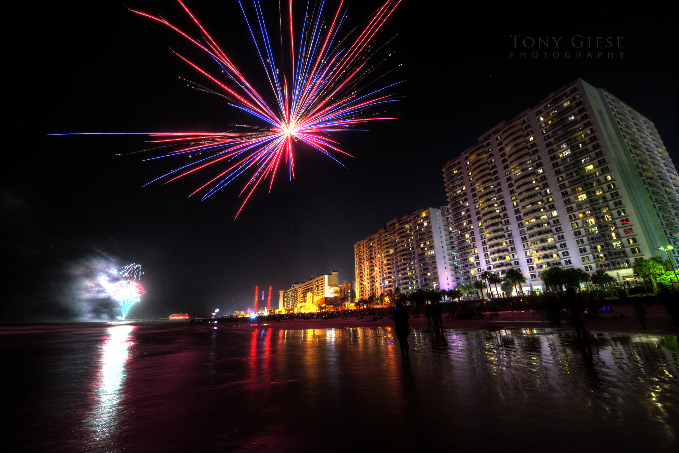 Fireworks in the far distance off the Main Street Pier  illuminating the ocean on Daytona Beach.